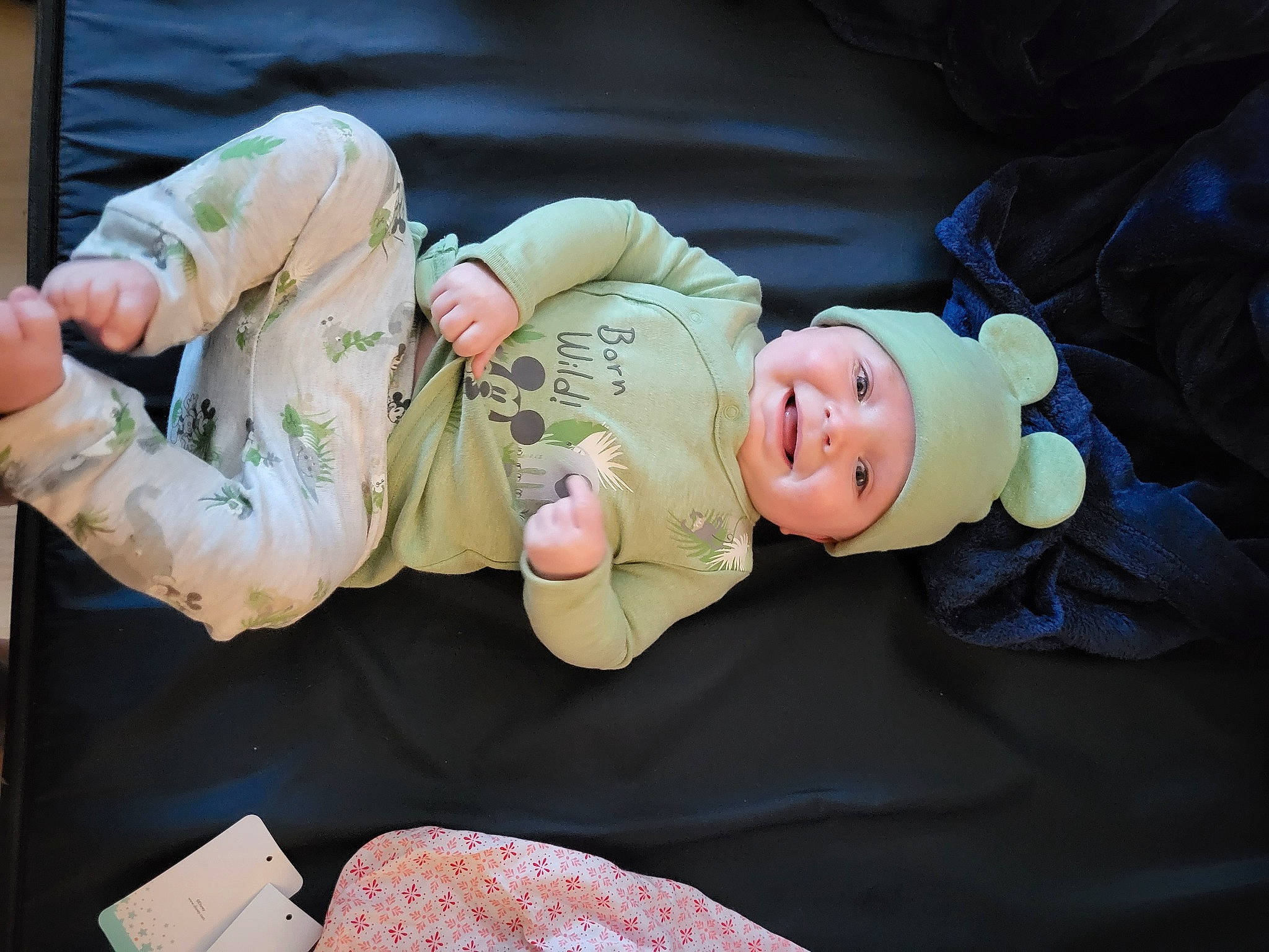 Allan is registered to the contest to win money with this photo: abdomen, baby, baby_products, baby_toddler_clothing, child, comfort, event, fun, gesture, hand, happy, hat, headwear, lap, mammal, person, room, sitting, smile, toddler