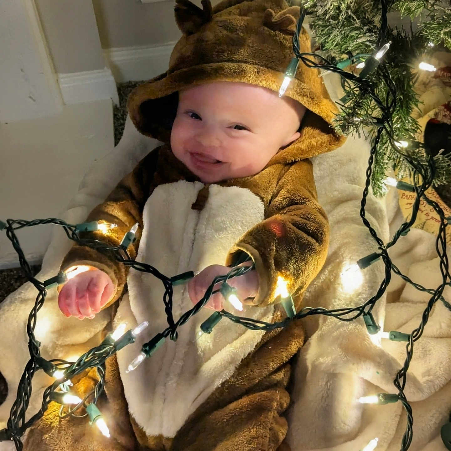 Owen is registered to the contest to win money with this photo: baby, blanket, celebration, child, christmas_lights, costume, cute, decorations, festive, happy, holiday, indoors, infant, playful, reindeer, smiling, soft_texture, toddler, tree, warm_clothing