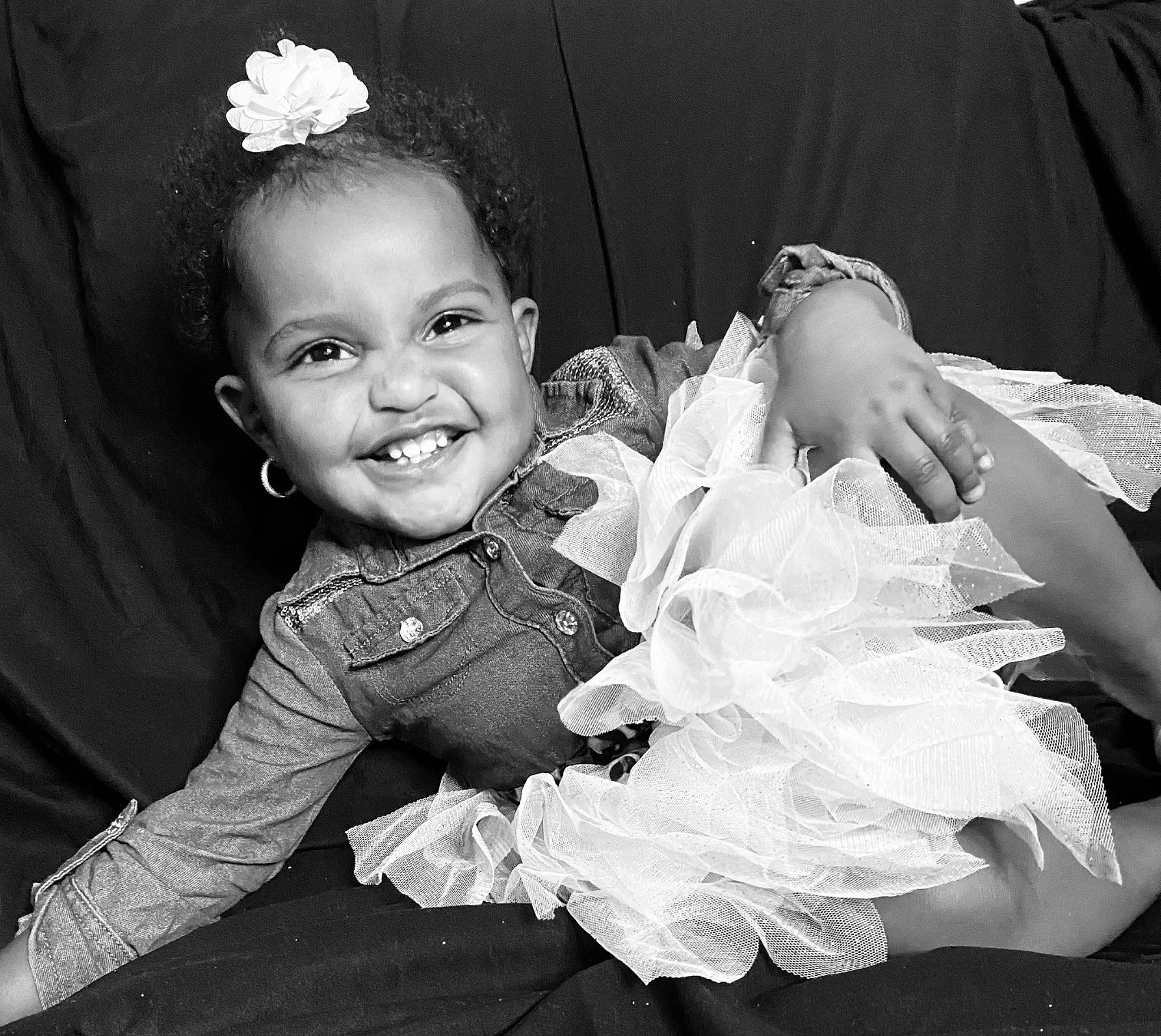 Amara is registered to the contest to win money with this photo: baby_toddler_clothing, black, black_and_white, dress, eye, face, flash_photography, gesture, hair, hairstyle, happy, head, iris, joy, monochrome, organ, person, smile, style, textile