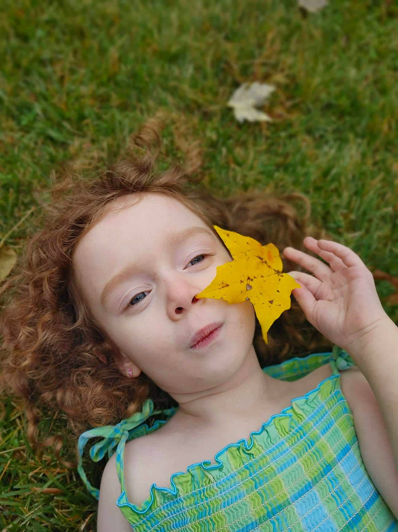 Annebelle is registered to the contest to win money with this photo: blond, botany, brown_hair, fun, grass, grass_family, grassland, hand, happy, leaf, lip, long_hair, meadow, pattern, people_in_nature, person, petal, plant, prairie, spring