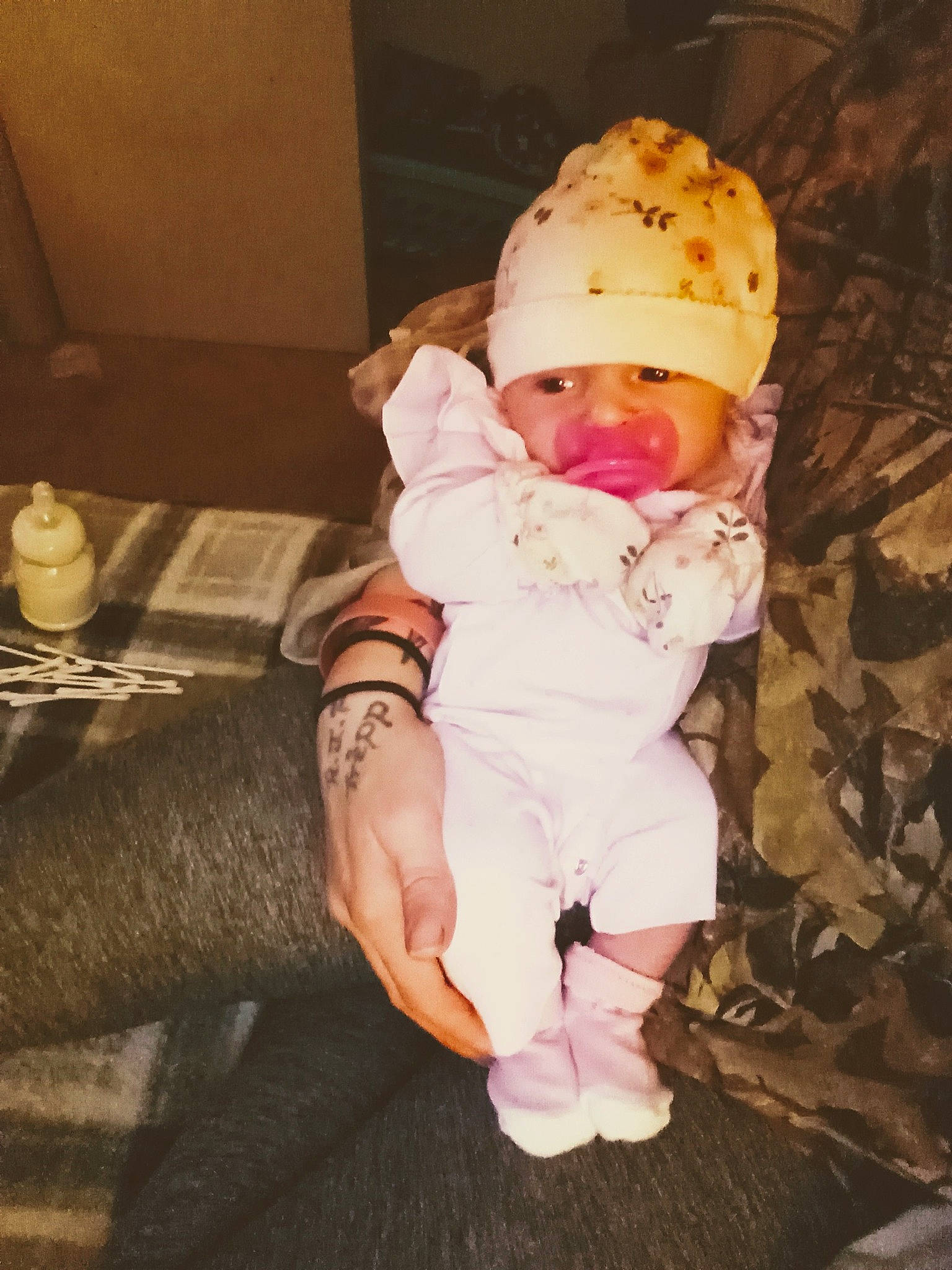 Heaven is registered to the contest to win money with this photo: baby, baby_toddler_clothing, cheek, comfort, eye, foot, fun, fur, hand, hat, human_leg, lap, peach, person, sitting, skin, sleeve, tableware, thigh, toddler