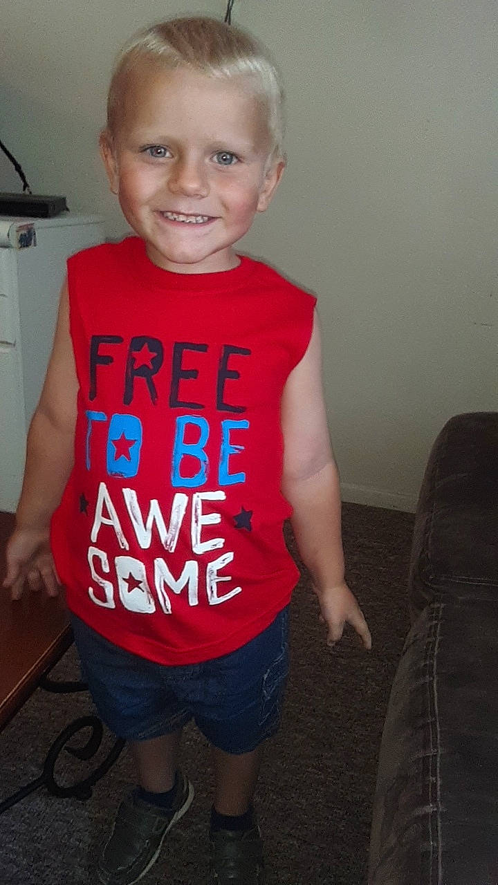 Owen is registered to the contest to win money with this photo: child, clothing, cool, joy, outerwear, person, shirt, shoulder, sleeve, standing, t_shirt, toddler, top