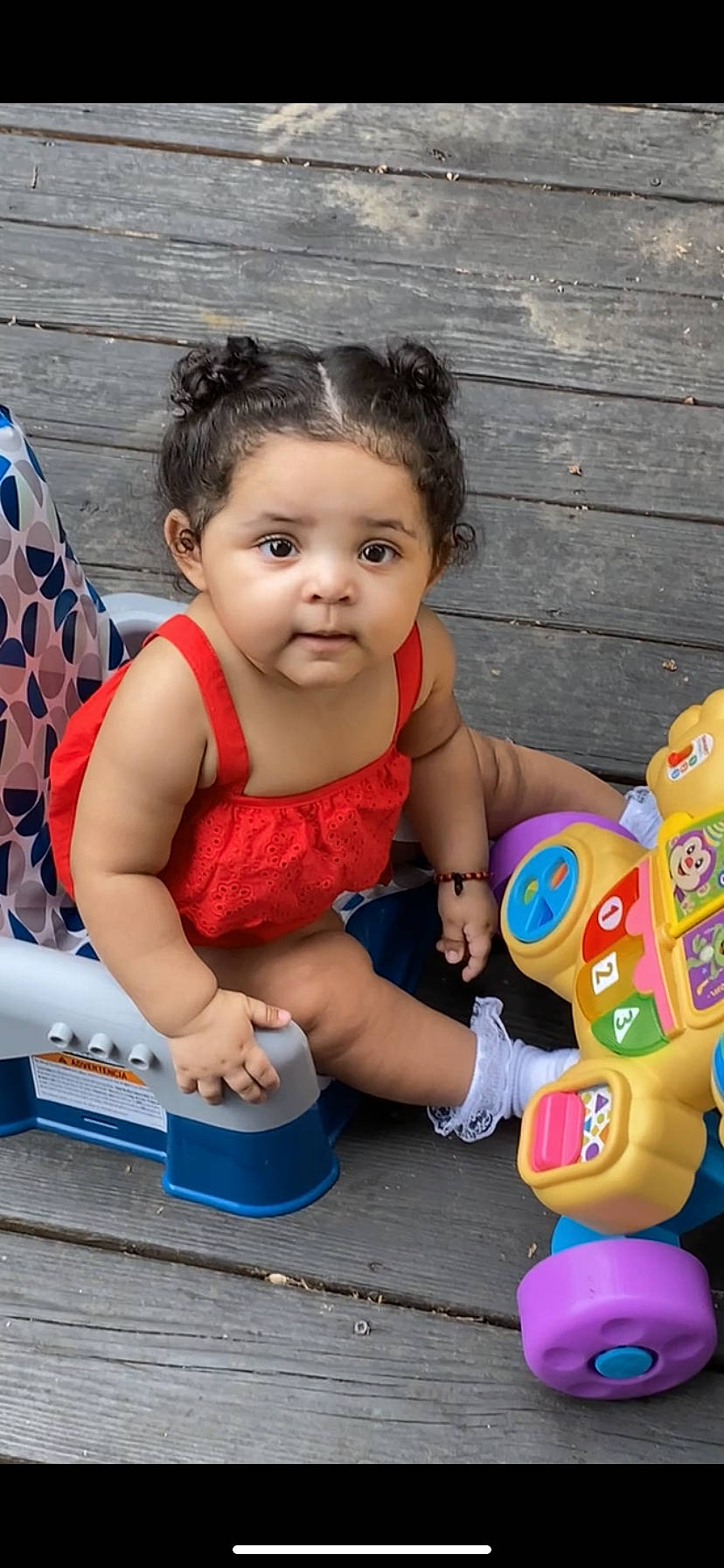 Naveyah is registered to the contest to win money with this photo: baby, baby_products, baby_toddler_clothing, blue, child, event, finger, flag, fun, grass, happy, leisure, pattern, person, pink, play, recreation, sitting, toddler, vacation