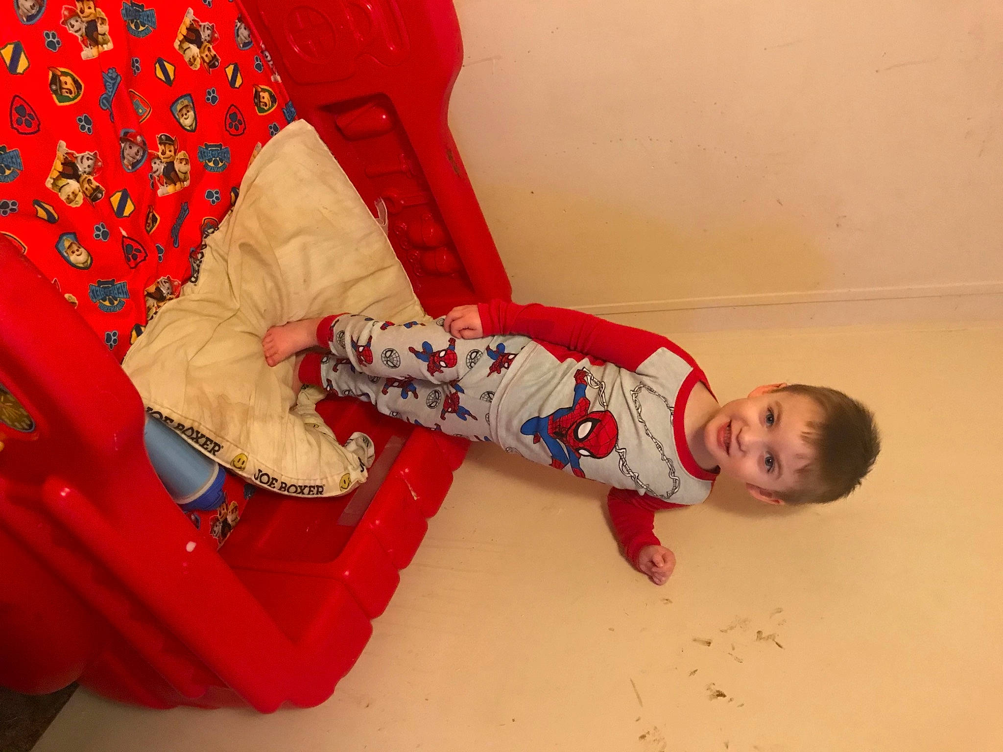Leiland is registered to the contest to win money with this photo: baby_toddler_clothing, carmine, child, comfort, flesh, flooring, foot, fun, happy, human_leg, joy, knee, magenta, pattern, person, room, sitting, sleeve, smile, sock