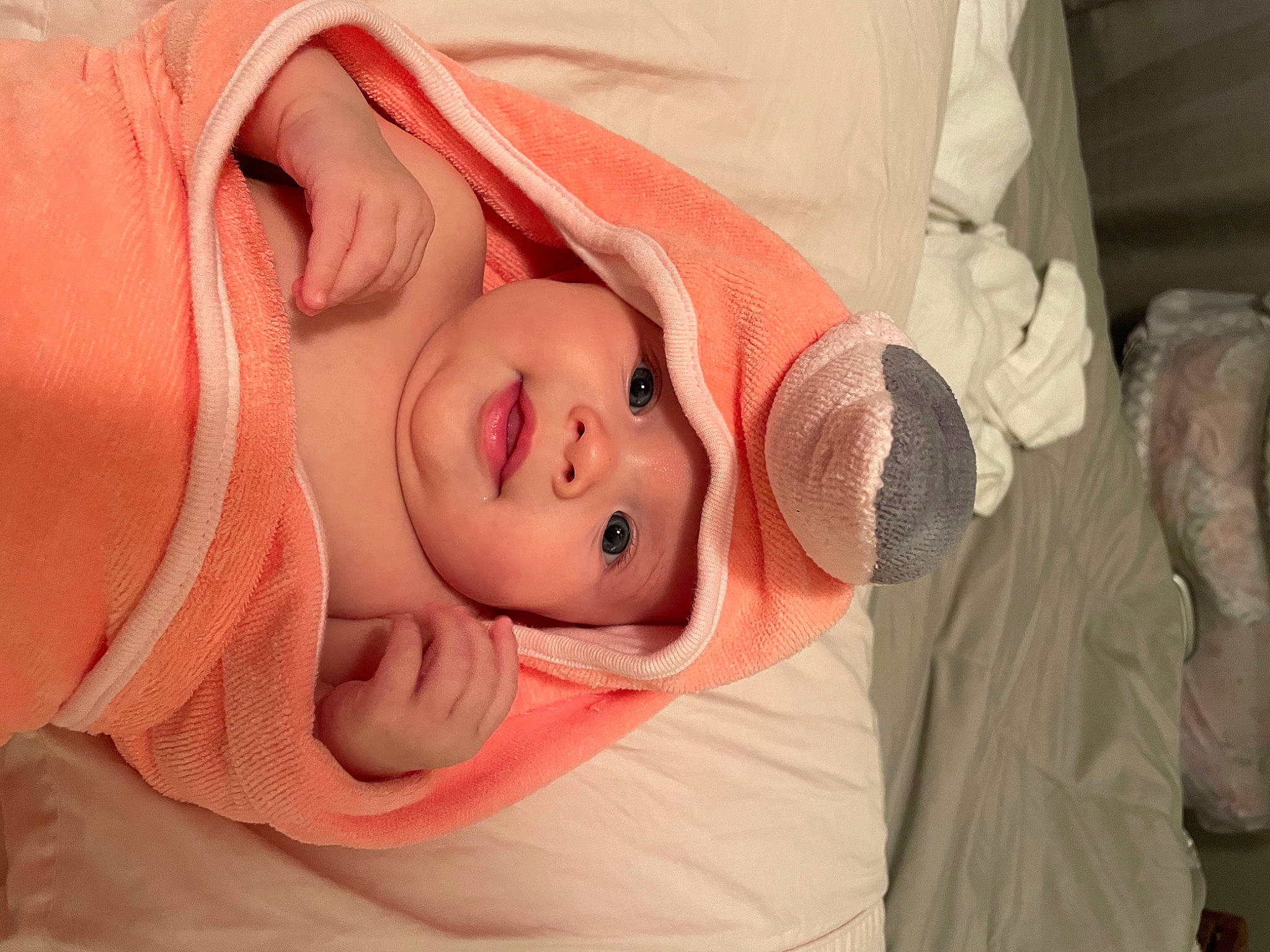 Sophia is registered to the contest to win money with this photo: arm, baby, baby_toddler_clothing, cheek, chin, ear, eye, eyebrow, eyelash, headwear, human_body, lip, mouth, neck, nose, orange, person, pink, skin, sleeve