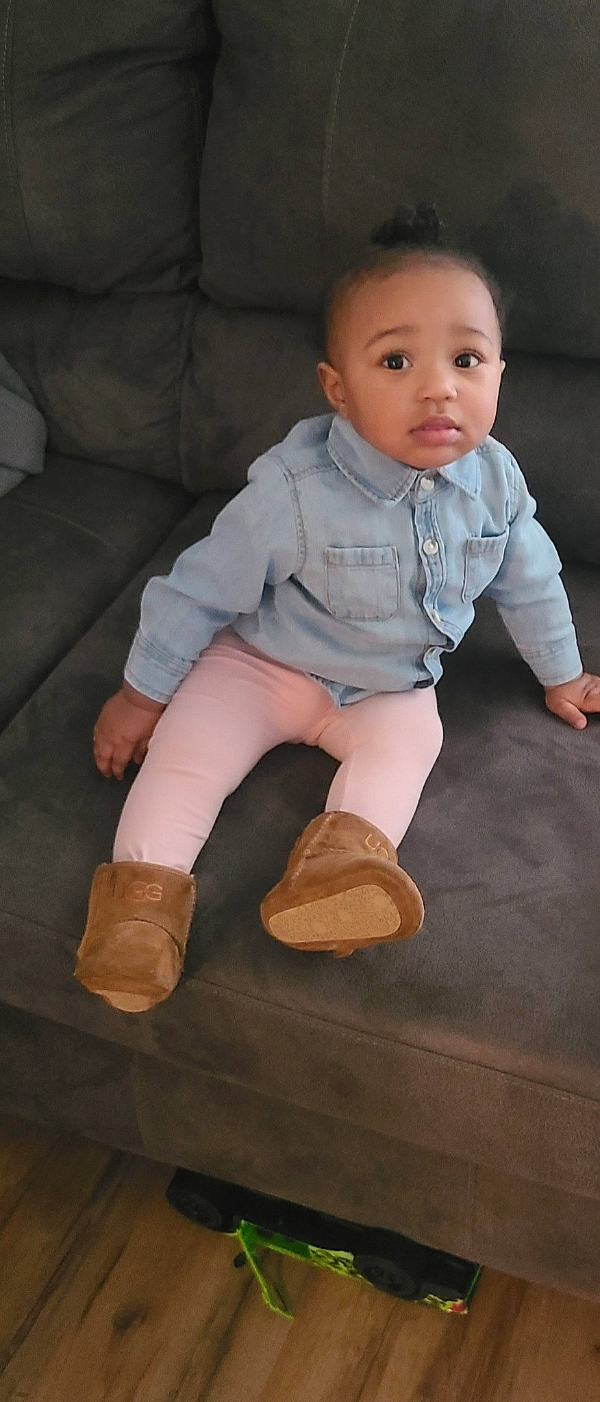 Janelle is registered to the contest to win money with this photo: arm, baby_toddler_clothing, cheek, chin, couch, eye, face, finger, flash_photography, head, human_body, joint, knee, leg, neck, nose, person, skin, sleeve, sock