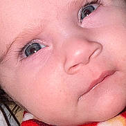 Mila Elysa participe au concours pour gagner de l'argent avec cette photo : baby, close_up, face, blue_eyes, blanket, infant, skin, eyelashes, portrait, cute, child, newborn, soft, warm, red, yellow, expression, head, person, young