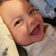 Liam joined the competition — help win amazing prizes! baby, smiling, close_up, face, infant, joyful, happy, child, skin, eyes, pillow, pattern, ant, cute, portrait, young, clothing, head, mouth, expression