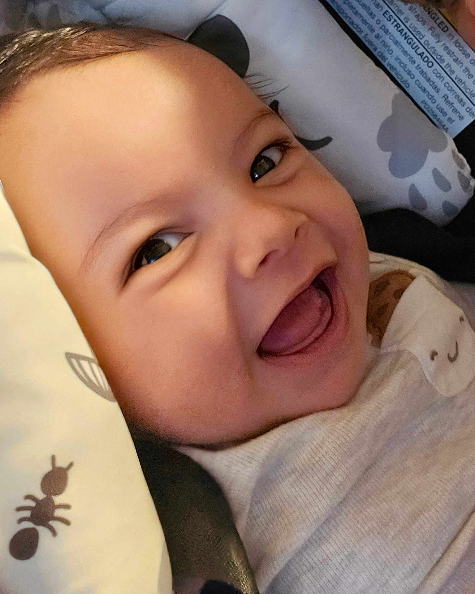 Liam joined the competition — help win amazing prizes! baby, smiling, close_up, face, infant, joyful, happy, child, skin, eyes, pillow, pattern, ant, cute, portrait, young, clothing, head, mouth, expression