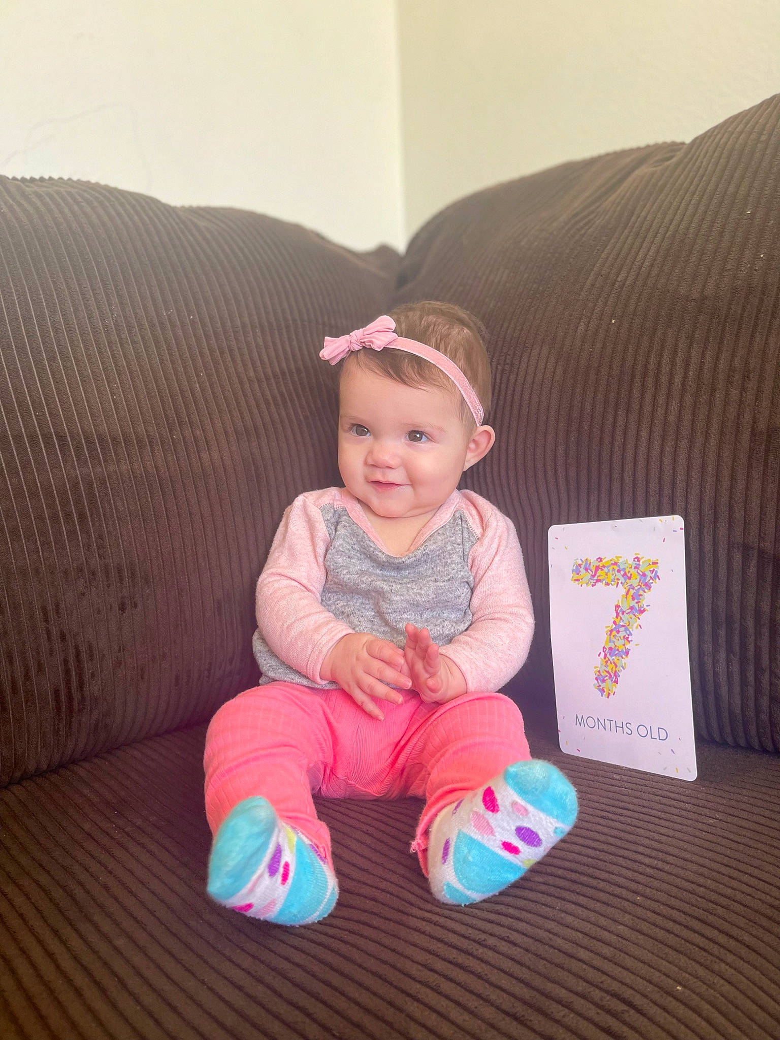 Celeste joined the competition — help win amazing prizes! baby, baby_toddler_clothing, cheek, child, comfort, couch, eye, face, finger, flooring, joy, leg, magenta, person, purple, sitting, skin, sleeve, smile, sock