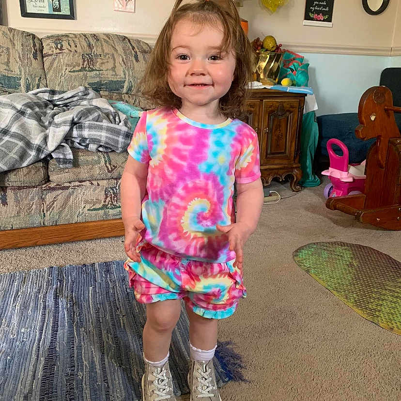 Carly is registered to the contest to win money with this photo: architecture, building, clothing, couch, cushion, face, footwear, furniture, head, homedecor, indoors, interiordesign, livingroom, person, photography, portrait, room, shoe, shorts, t_shirt