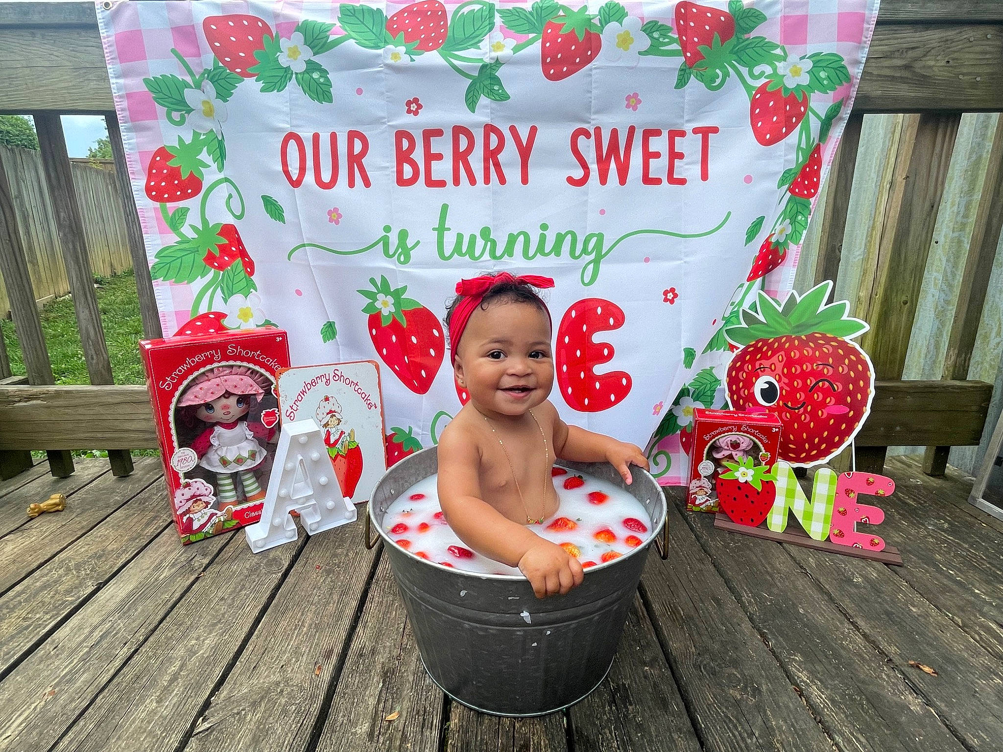 Addilee is registered to the contest to win money with this photo: advertising, baby, baby_toddler_clothing, child, event, font, grass, happy, hat, holiday, joy, pattern, person, pink, plant, rectangle, red, sitting, smile, sweetness