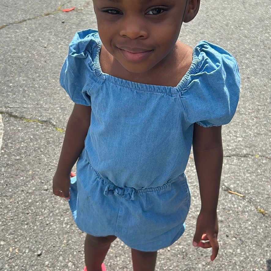 Callie joined the competition — help win amazing prizes! child, city, clothing, dress, face, female, footwear, girl, head, pants, person, photography, portrait, road, sandal, shoe, shorts, street, urban, walking