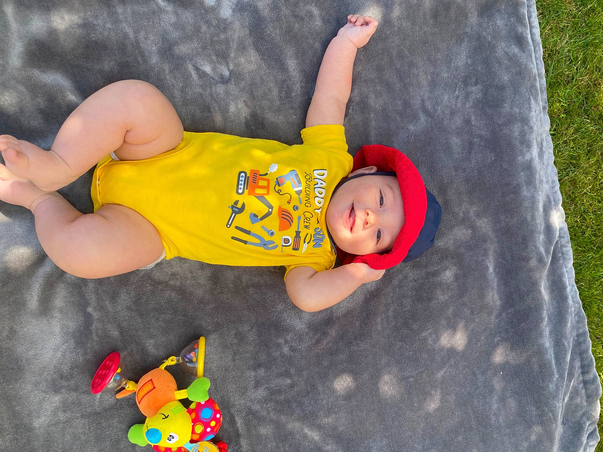 Makai joined the competition — help win amazing prizes! baby, baby_toddler_clothing, child, fictional_character, flooring, foot, fun, grass, headwear, human_body, human_leg, knee, leisure, people_in_nature, person, plant, play, sportswear, t_shirt, thigh