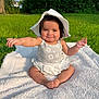 baby, blanket, child, cute, daisy_pattern, grass, greenery, happy, hat, infant, nature, outdoor, playful, portrait, sitting, smiling, summer, sunlight, toddler, white_hat