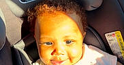 Miyori is registered to the contest to win money with this photo: baby, child, car_seat, pacifier, sunlight, curly_hair, smile, infant, clothing, clip, pink, seatbelt, safety, cute, portrait, indoors, happy, person, young_child, toddler