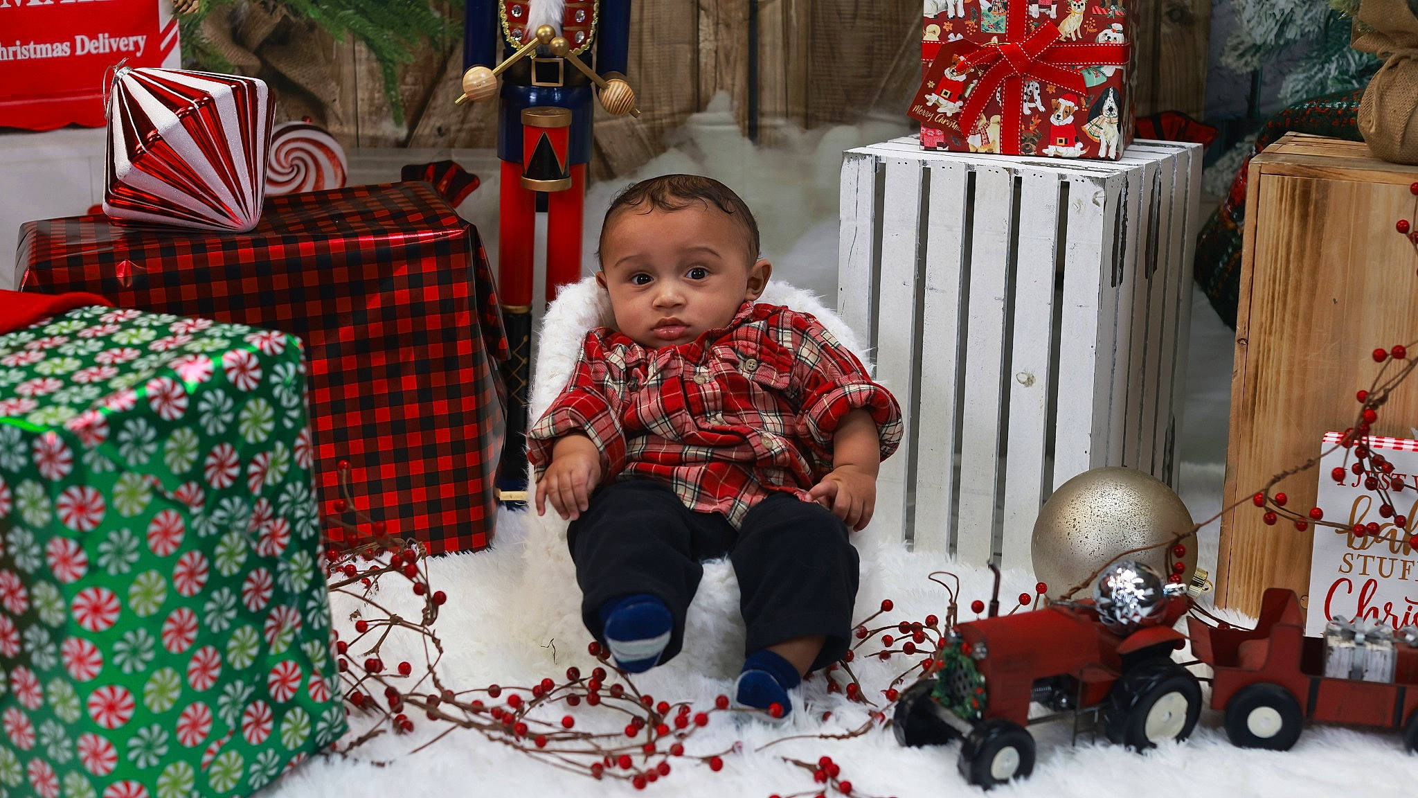 Joziah joined the competition — help win amazing prizes! baby, baby_toddler_clothing, child, christmas, christmas_decoration, christmas_eve, christmas_ornament, event, fun, holiday, pattern, people, person, plaid, red, tartan, toddler, toy, wheel, white