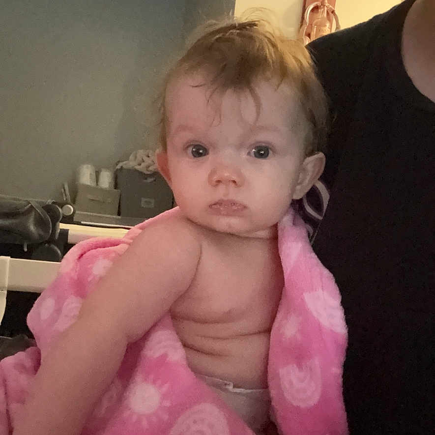 Melrose is registered to the contest to win money with this photo: baby, bathtowel, blanket, bodypart, clothing, couch, dress, face, finger, furniture, hand, head, homedecor, linen, newborn, person, photography, portrait, sitting, towel