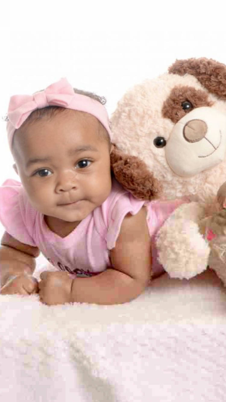 Analaya is registered to the contest to win money with this photo: baby, baby_toddler_clothing, cap, cheek, child, comfort, facial_expression, fur, happy, head, linens, nose, person, pink, primate, skin, smile, stuffed_toy, textile, toddler