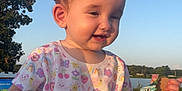 Bellamy joined the competition — help win amazing prizes! toddler, child, outdoor, sunlight, smiling, shirt, colorful_clothing, cardboard, lake, trees, nature, grass, happy, playful, baby, shorts, sitting, daylight, sky, cute