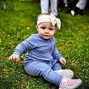 Waverley joined the competition — help win amazing prizes! baby, child, infant, grass, outdoor, blue_outfit, headband, bow, sitting, curious, cute, shoes, pink_shoes, green_grass, person, portrait, young_child, nature, daylight, casual_clothing