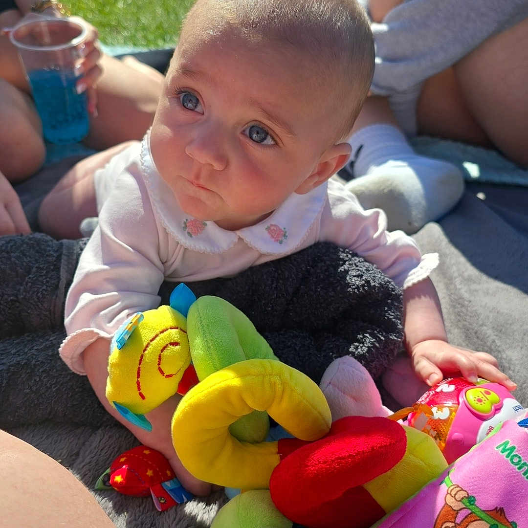 Mia-Mae joined the competition — help win amazing prizes! baby, bicycle, blanket, blue_eyes, casual, child, colorful, cute, grass, outdoor, park, people, person, play, plush_toy, relax, soft_toys, summer, sunlight, toy