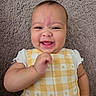 Amina joined the competition — help win amazing prizes! baby, smiling, happy, infant, yellow_clothing, checkered_pattern, carpet, texture, cute, face, child, portrait, hand, lying_down, indoors, skin, head, cheerful, baby_girl, one_person
