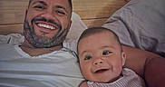 Elijah joined the competition — help win amazing prizes! baby, bed, casual, closeup, clothing, face, family, happy, indoor, infant, love, man, person, pillow, portrait, relaxation, skin, smile, togetherness, wooden_headboard