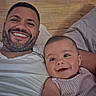 Elijah joined the competition — help win amazing prizes! man, baby, smile, face, portrait, bed, pillow, wooden_headboard, happy, family, indoor, casual, person, closeup, skin, clothing, infant, relaxation, togetherness, love