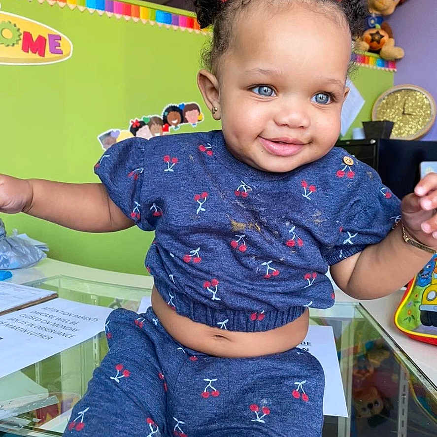 Xaylani is registered to the contest to win money with this photo: baby, bodypart, clothing, face, finger, hand, happy, head, indoors, interiordesign, jeans, laughing, mouth, pants, person, photography, portrait, smile, t_shirt, teeth