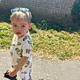 Tudor joined the competition — help win amazing prizes! child, toddler, outdoor, sunglasses, lion_king, shorts, shirt, sandals, pavement, grass, brick_wall, sunlight, daytime, person, cute, fashion, summer, young, casual, walking