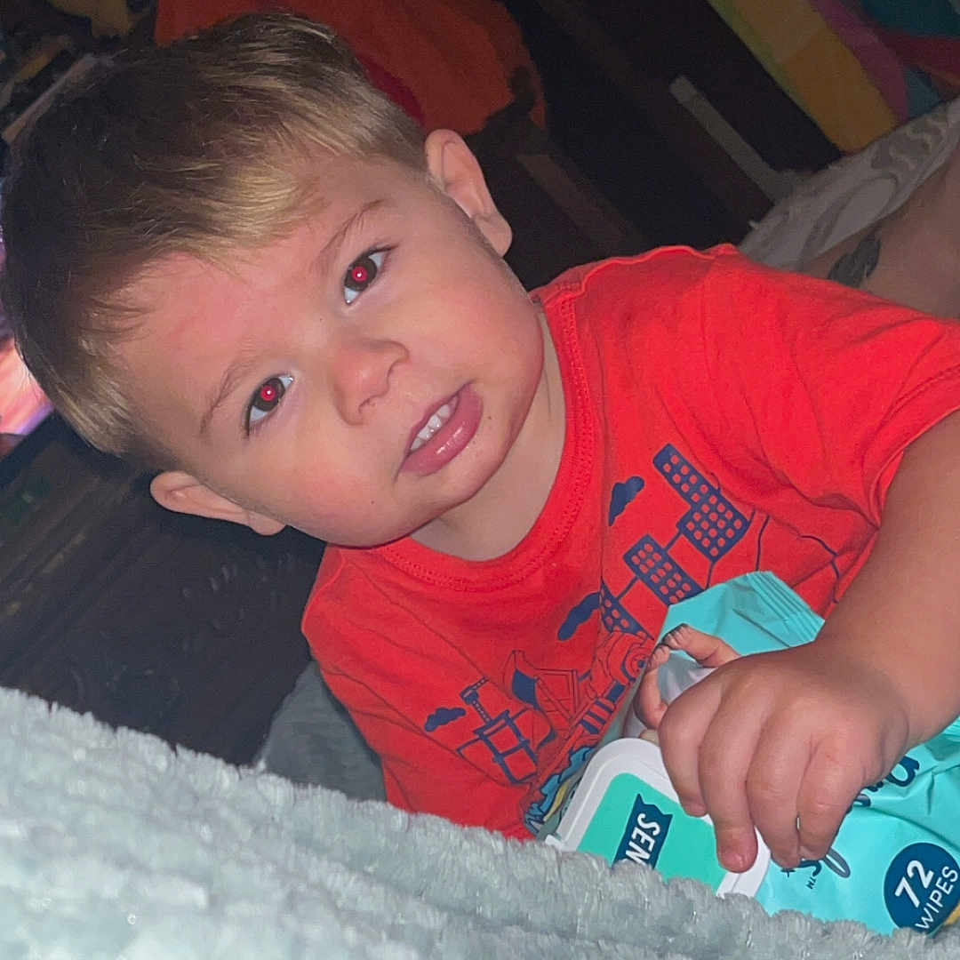 Bentley joined the competition — help win amazing prizes! baby, bed, bedroom, bodypart, clothing, couch, face, finger, furniture, hand, happy, head, indoors, mouth, person, photography, portrait, smile, t_shirt, teeth