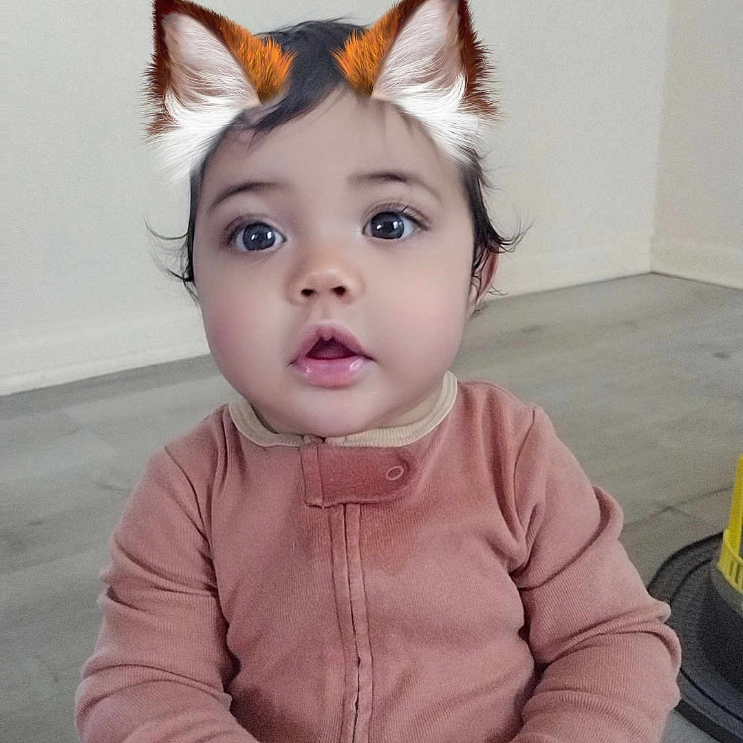 Emma joined the competition — help win amazing prizes! accessories, baby, bodypart, clothing, couch, face, finger, furniture, hand, hardwood, hat, head, knitwear, longsleeve, person, photography, portrait, sleeve, sweater, wood