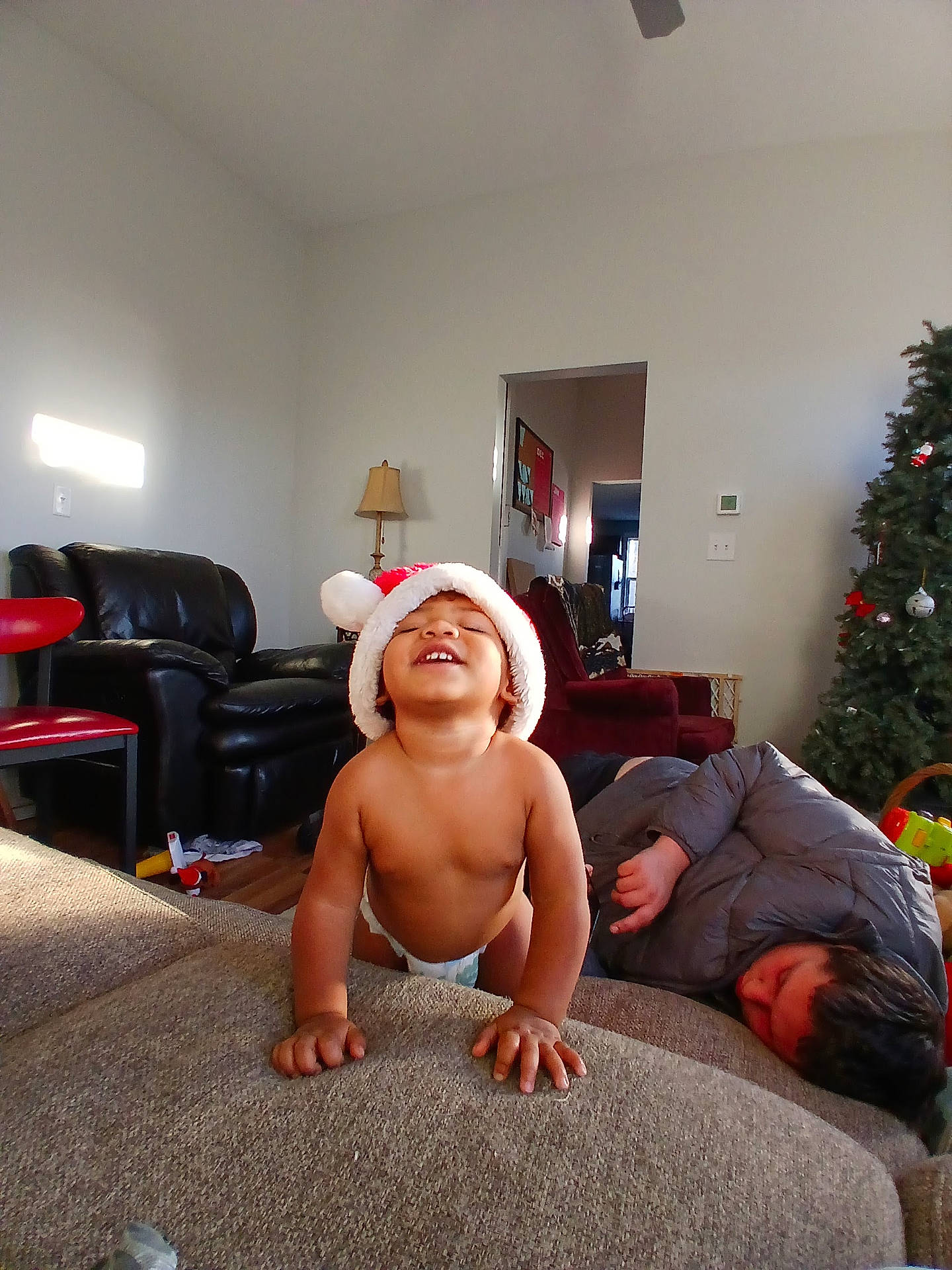 Malakai is registered to the contest to win money with this photo: adult, architecture, baby, building, chair, clothing, couch, face, furniture, hat, head, indoors, livingroom, male, man, person, photography, plant, portrait, room
