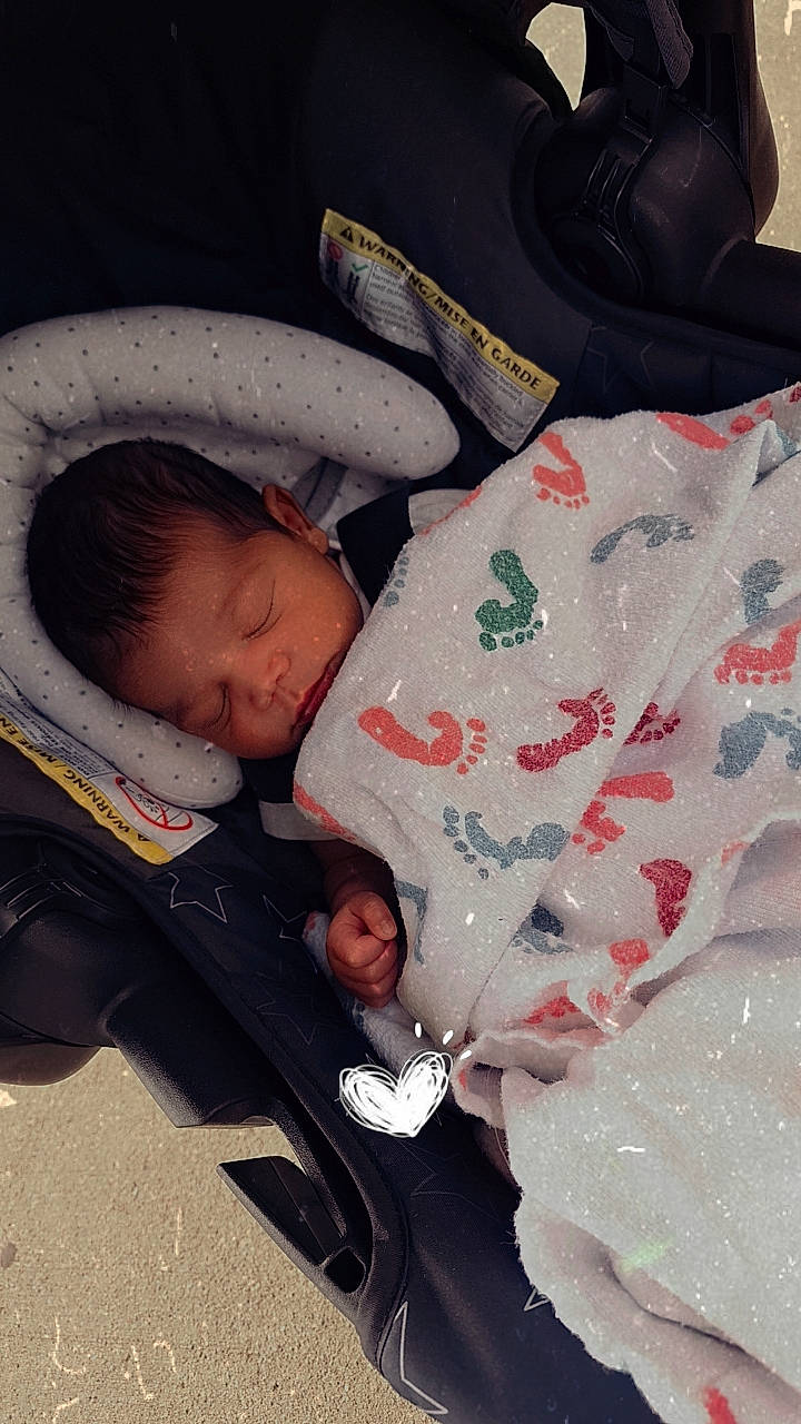 Malakai is registered to the contest to win money with this photo: baby, baby_carriage, baby_products, baby_safety, baby_sleeping, baby_toddler_clothing, bedtime, carmine, cheek, child, comfort, facial_expression, linens, nap, person, product, room, skin, sleeve, textile