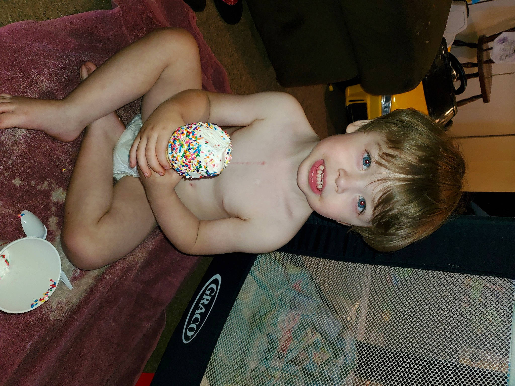 Wayne is registered to the contest to win money with this photo: abdomen, baby, barechested, brassiere, chest, elbow, eye, flooring, human_leg, joint, muscle, navel, person, shoulder, sitting, skin, swimwear, thigh, toddler, toy