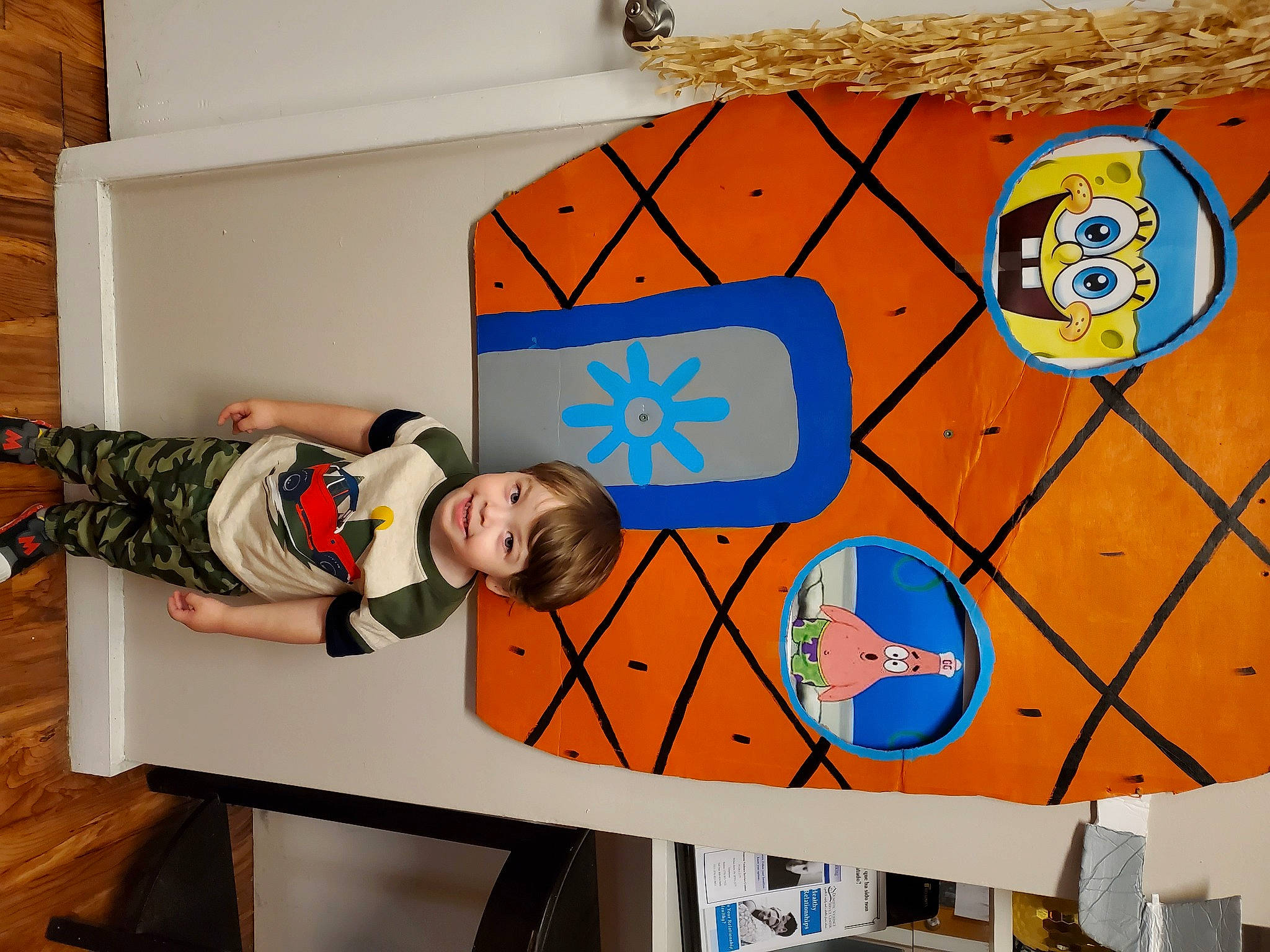 Wayne is registered to the contest to win money with this photo: art, child, circle, font, fun, graphics, joy, leisure, mural, orange, pattern, person, play, recreation, room, smile, space, t_shirt, toddler, visual_arts
