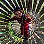 Emilio a rejoint le concours — aidez-le/la à gagner de superbes lots ! child, glasses, red_clothing, wooden_tunnel, rope, outdoor, adventure, playground, safety_harness, nature, trees, wooden_slats, curious, active, young_boy, casual_shoes, daylight, greenery, exploring, fun