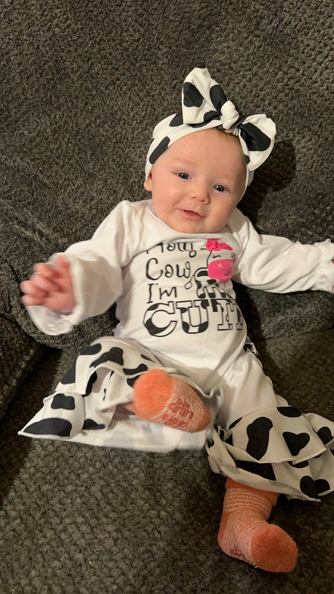 Emberlynn is registered to the contest to win money with this photo: baby, baby_products, baby_toddler_clothing, cap, carmine, cheek, child, comfort, eyewear, facial_expression, happy, hat, pattern, person, sitting, sleeve, smile, sock, t_shirt, toddler