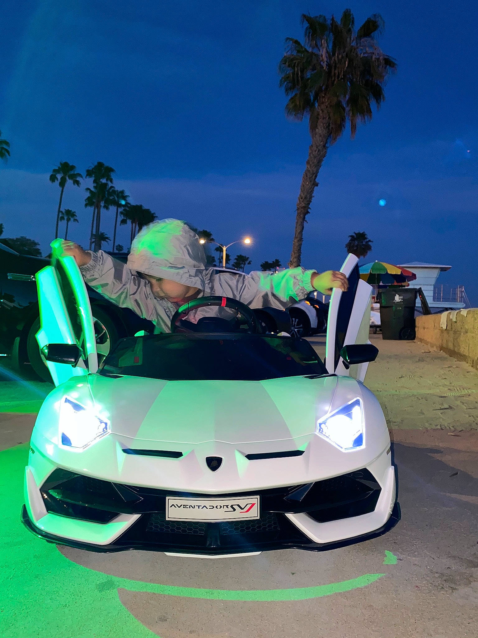 Julius joined the competition — help win amazing prizes! arecales, automotive_design, automotive_exterior, automotive_fog_light, automotive_lighting, bumper, car, event, green, headlamp, hood, mode_of_transport, motor_vehicle, palm_tree, person, personal_luxury_car, sky, tire, tree, vehicle
