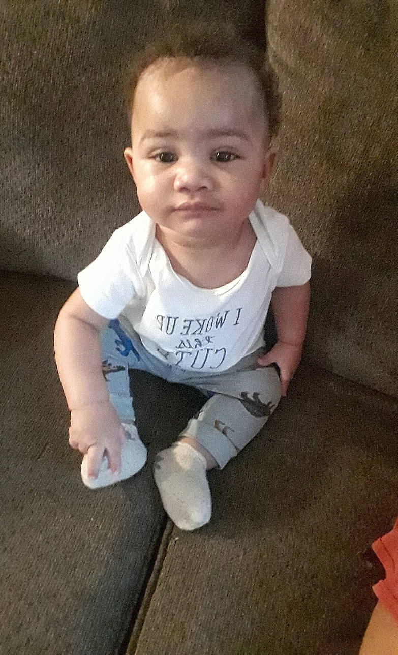 Seth is registered to the contest to win money with this photo: arm, baby, baby_toddler_clothing, cheek, child, crawling, person, sitting, skin, smile, toddler