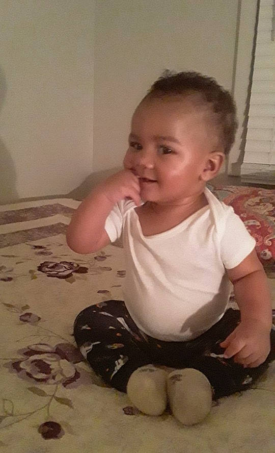 Seth is registered to the contest to win money with this photo: baby, baby_toddler_clothing, cheek, child, finger, hand, person, play, sitting, skin, thumb, toddler