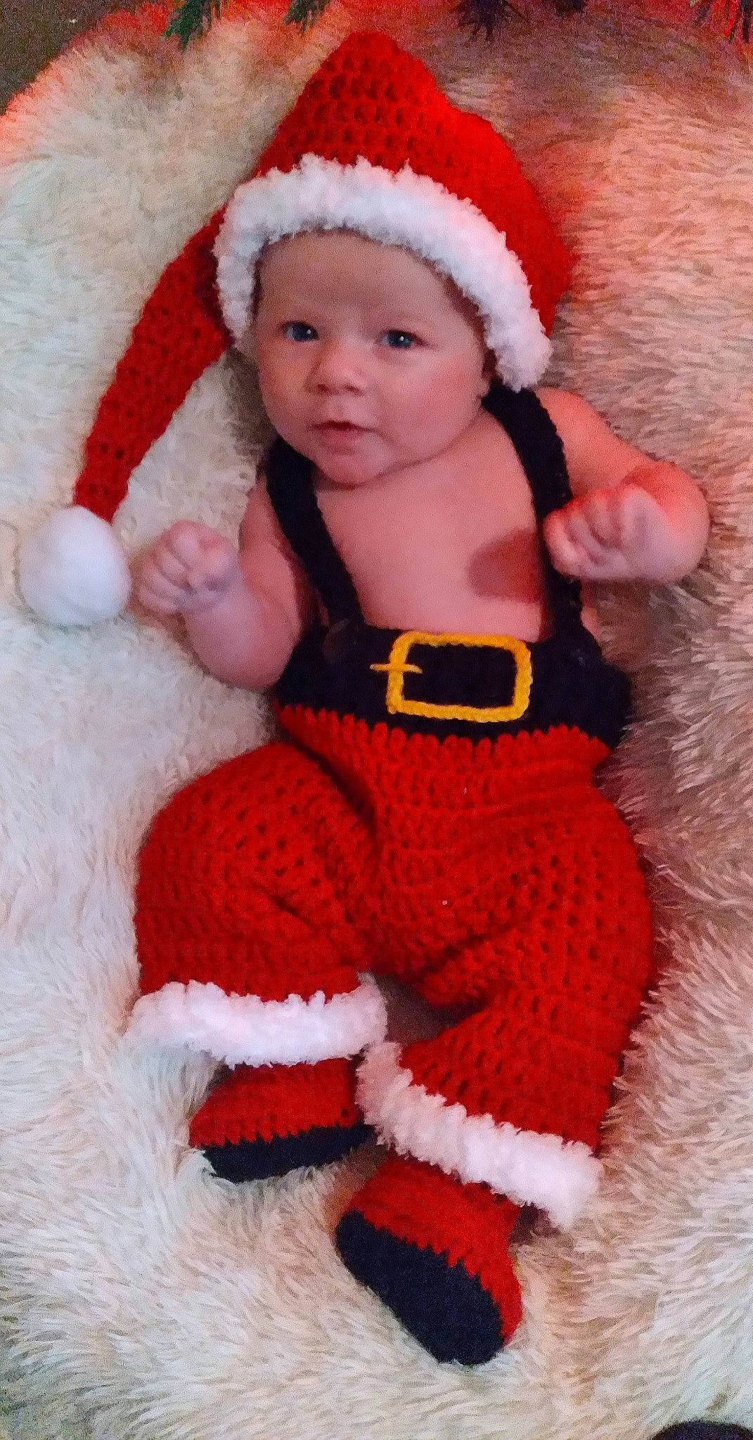 Robert is registered to the contest to win money with this photo: baby, baby_toddler_clothing, cap, cheek, eye, face, finger, fur_clothing, hand, head, headgear, headwear, lip, mammal, outerwear, person, pink, red, santa_claus, skin