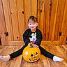 Rosalynn is registered to the contest to win money with this photo: toddler, child, pumpkin, jack_o_lantern, halloween, floor, wooden_floor, sweater, minnie_mouse, smile, indoor, wooden_wall, legs, socks, cute, holiday, orange, black_clothing, happy, playful