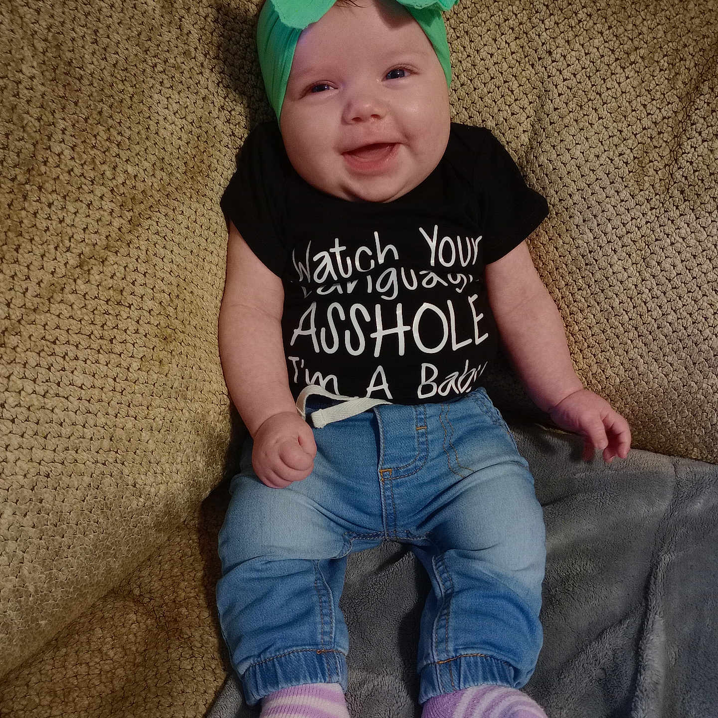 Mattie is registered to the contest to win money with this photo: baby, cap, clothing, couch, cushion, face, furniture, hat, head, homedecor, hosiery, jeans, newborn, pants, person, photography, portrait, sitting, sock, t_shirt
