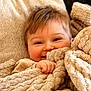 baby, blanket, child, closeup, comfort, cozy, cuddly, cute, face, fuzzy, hand, happy, indoors, person, portrait, resting, smiling, soft_texture, warm, young_child