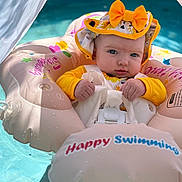Kinsleigh joined the competition — help win amazing prizes! baby, infant, pool, water, float, inflatable, hat, yellow, sunflower, outdoor, summer, swimming, cute, child, person, face, expression, sunlight, safety, fun