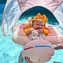Kinsleigh is registered to the contest to win money with this photo: baby, infant, pool, swimming_float, water, sunshade, yellow_clothing, hat, happy, outdoor, summer, tattoo, hand, safety, child, inflatable, blue_water, sunlight, relaxation, smile