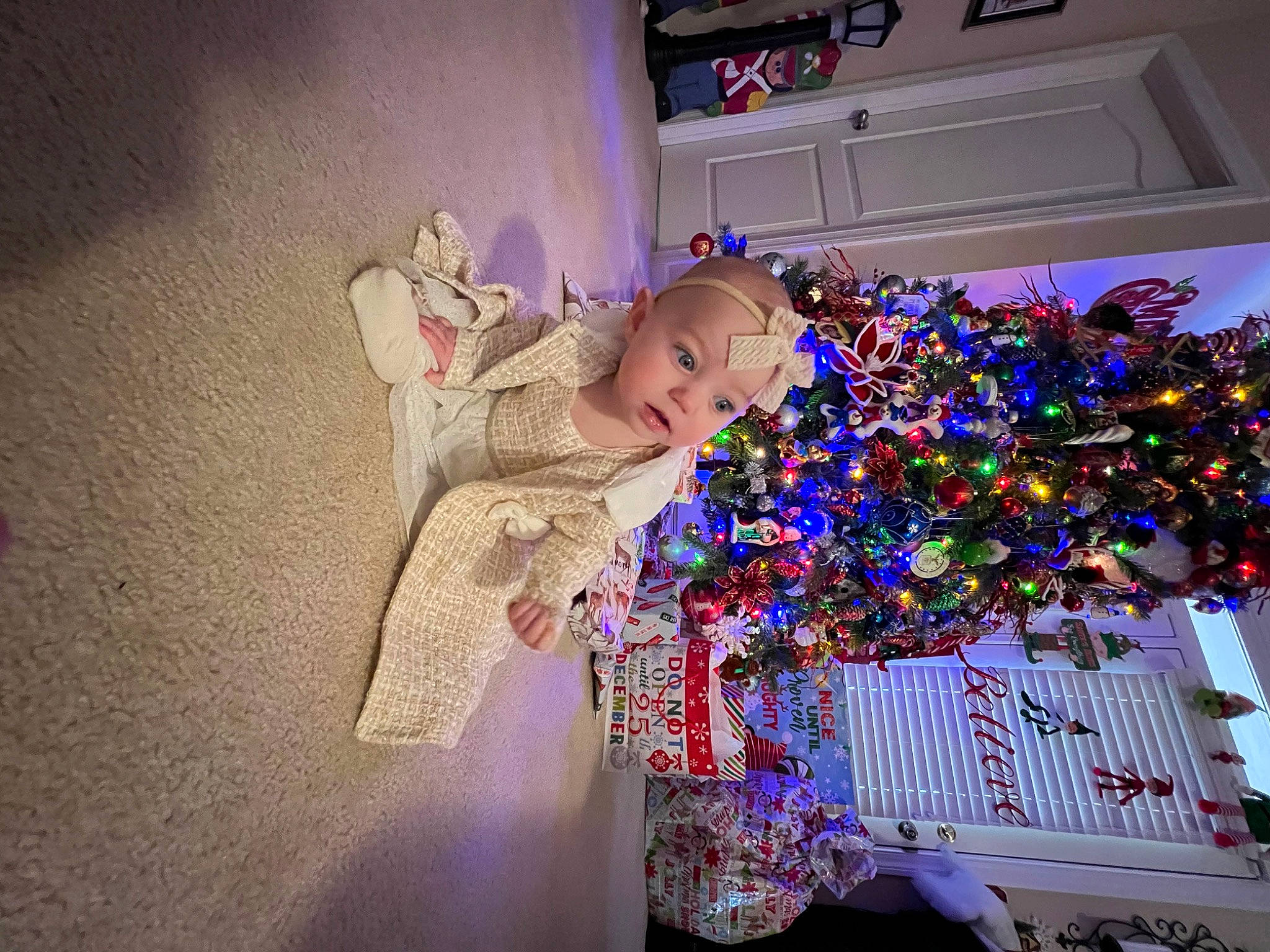 Lakelynn joined the competition — help win amazing prizes! baby, child, christmas, christmas_decoration, christmas_eve, christmas_lights, christmas_ornament, christmas_tree, event, fun, happy, holiday, holiday_ornament, interior_design, ornament, person, plant, purple, room, toddler