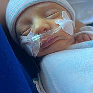 Silas is registered to the contest to win money with this photo: newborn, baby, infant, sleeping, hat, blanket, nasal_tube, medical, closeup, face, skin, person, peaceful, resting, healthcare, hospital, cute, tiny, child, wrapped